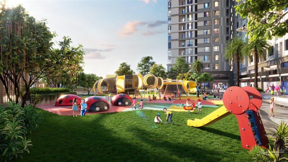 A playground with slide and buildings in the backgroundDescription automatically generated